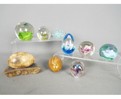 Seven paperweights to include Millrace, Caithness and similar, stone eggs and other.
