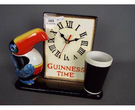 Breweriana - A ceramic Guinness advertising clock with toucan and pint glass, bearing slogan 'Guinness Time', approximately 2