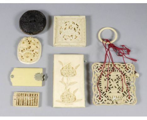 A Chinese Ivory Boxed Tangram Puzzle, 19th Century, the lid and puzzles pierced and carved with flowers and leaves, 2ins (5.1