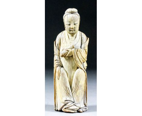 A Chinese Carved Ivory Seated Figure of a Lady, Ming dynasty, of archaic form holding a scroll, 6.5ins (16.5cm) high Note: Pl