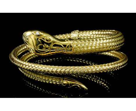 An 18ct Gold Serpent Pattern Flexible Bangle, Modern, with diamond set eyes, gross weight 49.5g