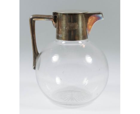 An Edward VII Silver Topped Bulbous Glass Claret Jug, by Hukin &amp; Heath, London 1901, the plain mounts with flat lid and a