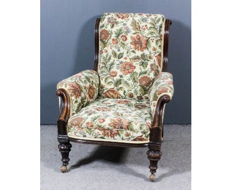 A Mahogany Scroll Back Easy Chair, William IV, with moulded showwood frame, scroll carved arm terminals, upholstered in flora