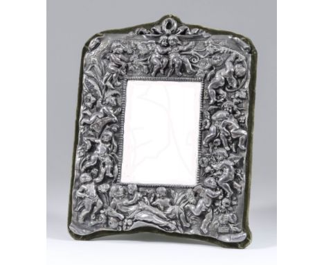 A Continental "Sterling" Silver Framed Rectangular Dressing Table Mirror, the frame with ribbon cresting cast with a reclinin