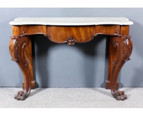 A Mahogany and Marble Topped Console Table, Victorian, of shaped and moulded outline, the shaped frieze fitted one drawer, on