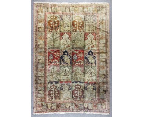 A Good Antique Silk Kayseri Carpet woven in muted shades with a tile design with twenty rectangular panels filled with stylis