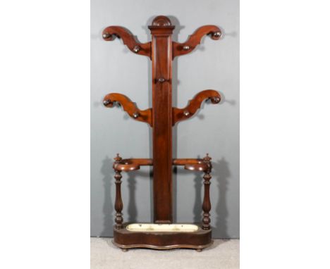 A Mahogany Hall Stand, Victorian, the rectangular panelled back with arched cresting, fitted four shaped branches with turned