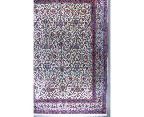 A Khorassan Carpet, 20th Century, woven in navy blue, ivory and wine, the field filled with trailing palmettes and floral lea