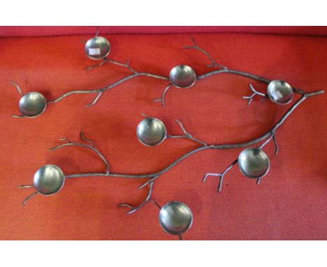 A metal silver table decoration/tealight holder in the form of a branch