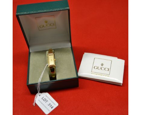 Ladies Gucci gold plated bangle watch in original box with paperwork 
Condition: Not working, possibly just requires a new ba