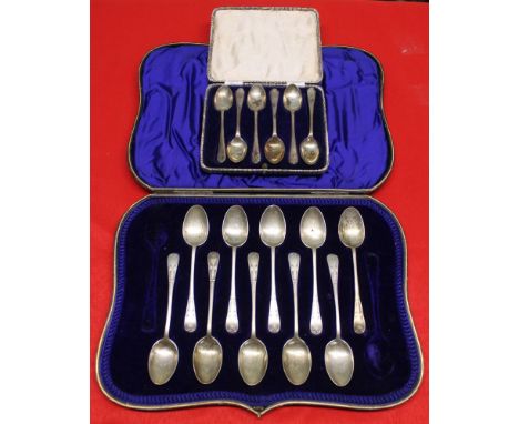 A cased set of six silver coffee spoons with Golf club terminals, together with a part case of ten silver teaspoons, combined