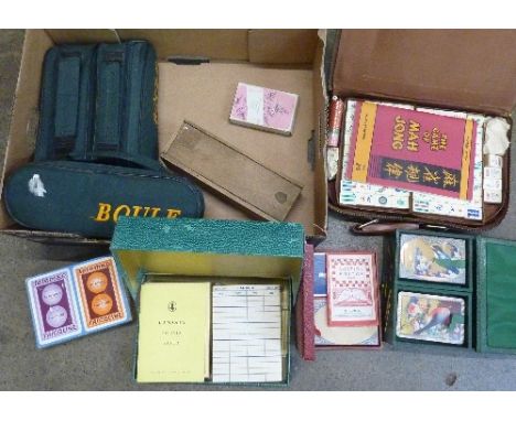 A box of games including Mah Jong, dominoes, boules, advertising playing cards, etc.