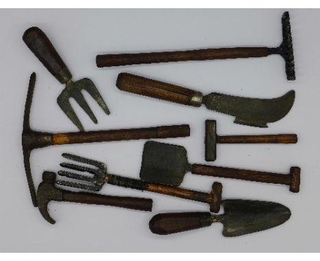 A collection of nine miniature tools, length of rake 12.5cm