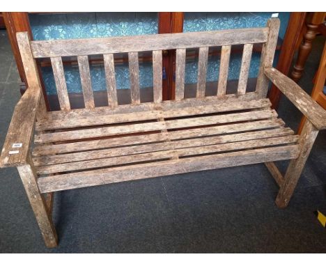 A WEATHERED TEAK GARDEN BENCH 4FT WIDE