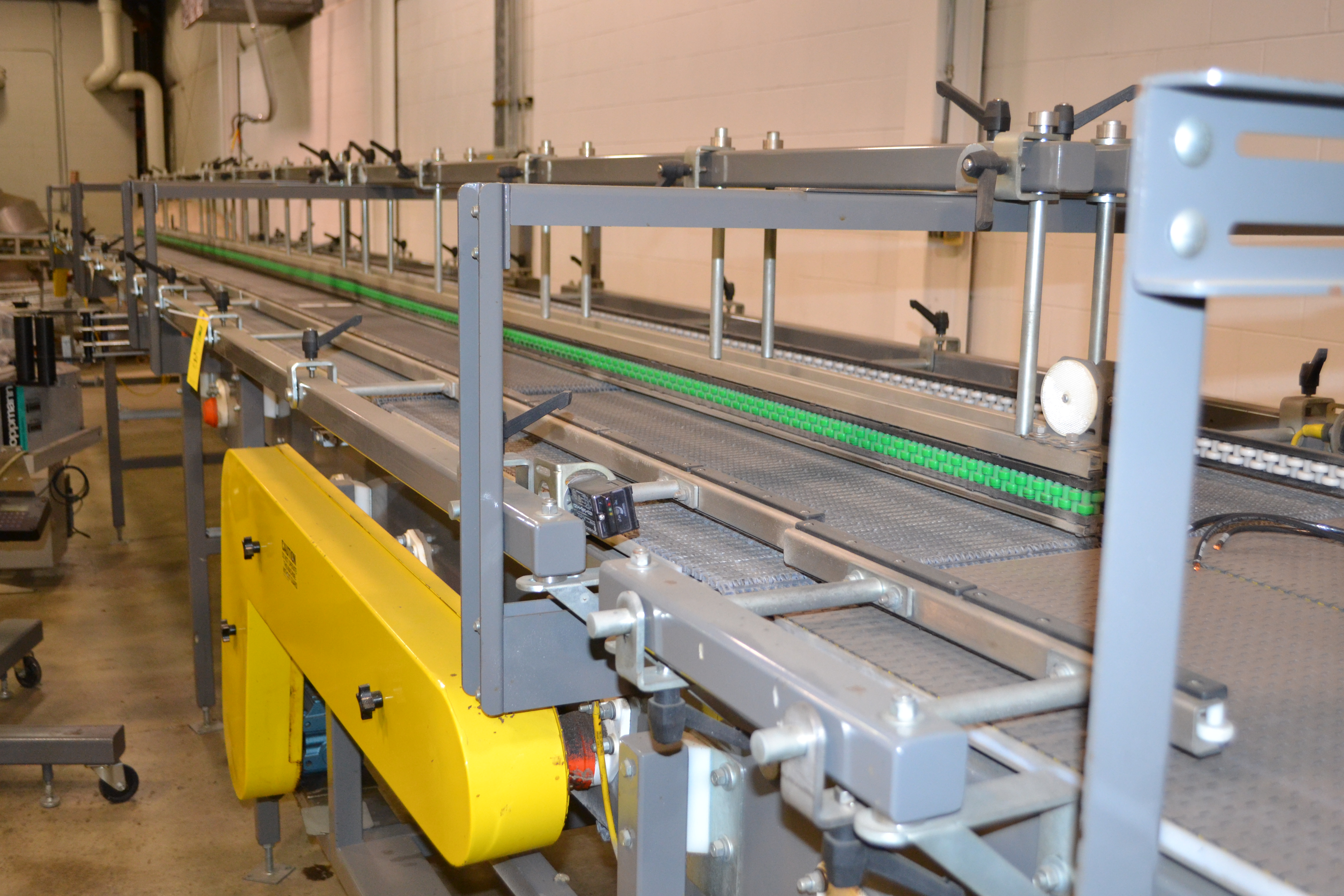 Mild steel 'beaded belt' tray conveyor, dual lane system with single