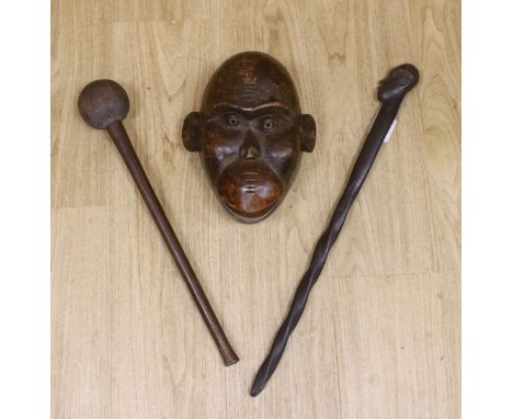 A tribal mask, a Knobkerrie and stick with carved head, stick 62.5cm