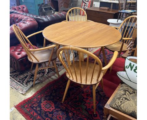 An Ercol oval elm drop leaf dining table, length 123cm extended, width 113cm, height 71cm and four Ercol elm and beech elbow 