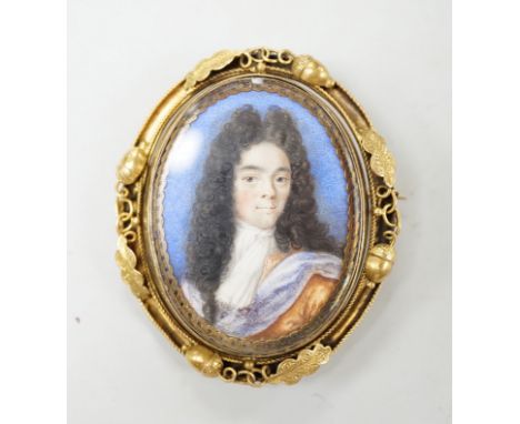 A Georgian yellow metal mounted oval portrait watercolour of a gentleman, with acorn and leaf border, 58mm.