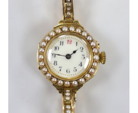 A lady's early 20th century 18ct gold and seed pearl set manual wind wrist watch, on a flexible 15ct and seed pearl set brace