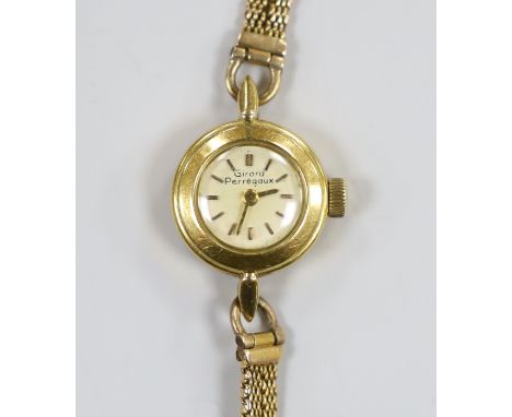 A lady's yellow metal Girard Perregaux manual wind wrist watch, on a 9ct twin strand bracelet, gross weight 12.6 grams, with 