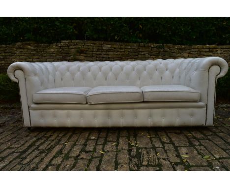 A three seater Chesterfield sofa in deep buttoned and studded leather upholstery. H.70 W.217 D.80cm 