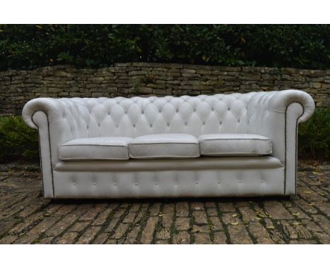 A three seater Chesterfield sofa in deep buttoned and studded leather upholstery. H.70 W.180 D.80cm 