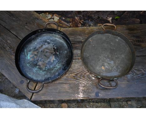 A pair of vintage copper and brass twin handled pans 