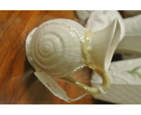 BELLEEK/CERAMIC/IRISH: A Belleek small creamer/milk jug in the seashell design.  Gold stamp-7th period mark/1st gold/ brown 1