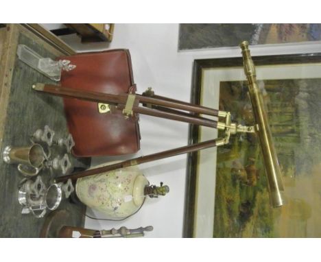 COLLECTABLES - A vintage reproduction brass telescope mounted on a small extending tripod. Telescope measures 62cm long. 