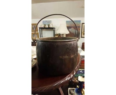 COLLECTABLES - A vintage large black enamel metal pot, measuring 19cm tall.