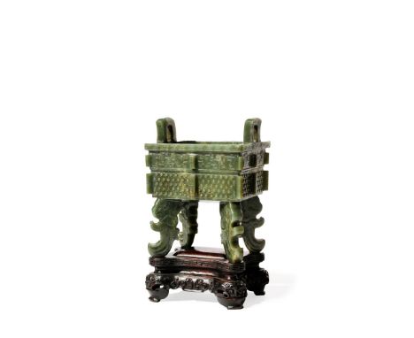 A CHINESE SPINACH-GREEN JADE ARCHAISTIC INCENSE BURNER, DING, LATE QING DYNASTY The rectangular body with two loop handles, c