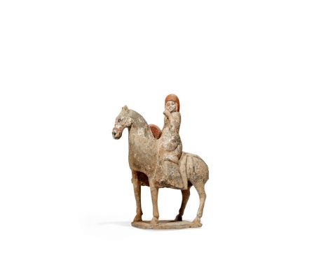 A CHINESE POTTERY MODEL OF A HORSE AND RIDER, NORTHERN WEI DYNASTY 386-535 AD The equestrian rider seated astride his steed, 