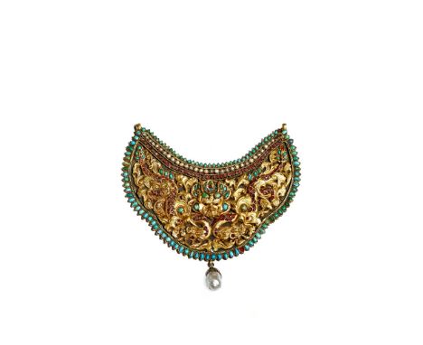 A NEPALESE GILT METAL NECKLACE OR BREAST PLATE, 18TH/19TH CENTURY Decorated in relief with two elaborate writhing dragons, th
