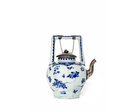 A CHINESE BLUE AND WHITE EWER, C.1640 With an octagonal base and a straight bail handle, painted with sprays of peony, lotus,