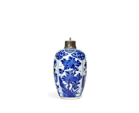 A CHINESE BLUE AND WHITE OVOID VASE, KANGXI 1662-1722 Painted with four panels of flowering sprays emerging from rocks, all b