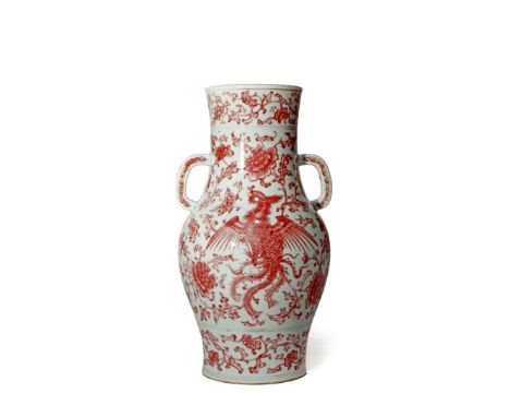 A CHINESE UNDERGLAZE RED VASE, 19TH CENTURY The wide cylindrical neck with two lug handles, the ovoid body painted with a pho