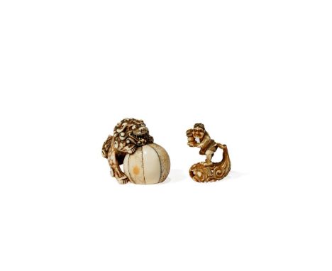 † TWO JAPANESE IVORY NETSUKE, 18TH AND 19TH CENTURY The first a shishi climbing on a ball, baring its teeth and with a long c