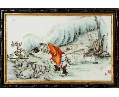 A CHINESE PORCELAIN RECTANGULAR PLAQUE, 20TH CENTURY Depicting the demon-slayer Zhong Kui sharpening his sword, a six charact