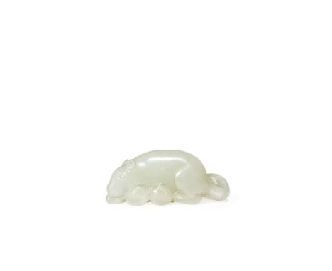 A SMALL CHINESE PALE CELADON JADE CARVING OF A SQUIRREL, 17TH CENTURY Crouching with its head lowered and the tail curled beh