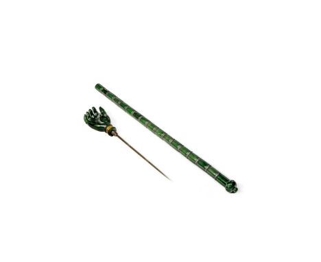 AN INDIAN SPINACH-GREEN JADE DAGGER, 19TH/20TH CENTURY Doubling as a back scratcher, the cylindrical shaft with concentric me