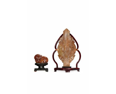 TWO CHINESE ARCHAISTIC BROWN JADE CARVINGS, QING DYNASTY One modelled as a recumbent hound, its flank decorated with C-scroll