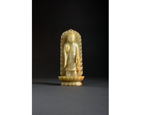 A CHINESE CELADON JADE CARVING OF SAKYAMUNI BUDDHA, PROBABLY LATE QING DYNASTY Standing on a double lotus base with a flaming