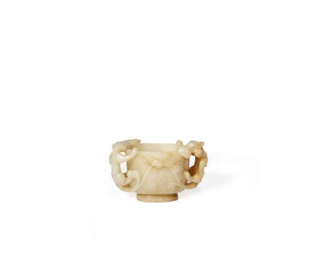 A CHINESE PALE CELADON JADE TWO-HANDLED CUP, MING DYNASTY The U-shaped cup carved with two sinuous chilongs climbing to the r