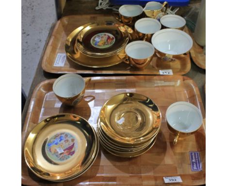 Two trays of Czechoslovakian teaware on a gold finish ground with Classical figural decoration, comprising: cups; saucers; pl