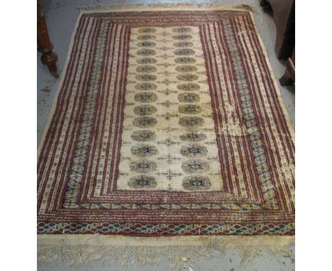 Middle Eastern design carpet on a beige ground with geometric, multicoloured decoration.(B.P. 24% incl. VAT)