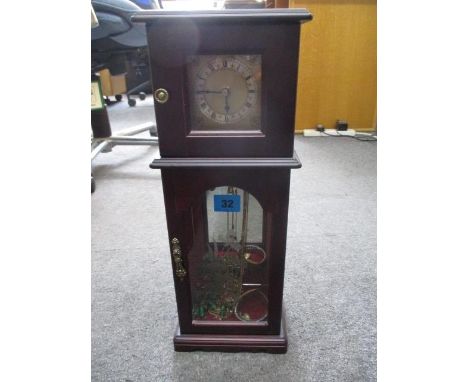 A small selection of costume jewellery all contained in a glass fronted jewellery box fashioned as a longcase clock 