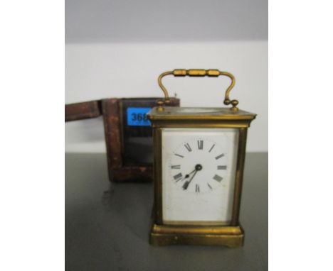A gilt brass carriage clock in a leather case 