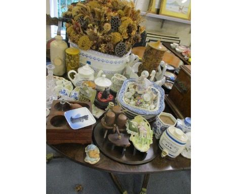 A china trough containing a dried flower arrangement, along with other ceramics and miscellanea