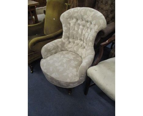 A  Victorian upholstered, button back armchair, raised on walnut cabriole front legs 