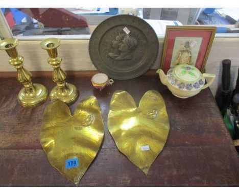 A mixed lot to include a pair of brass plaques fashioned as lily pads, a pair of brass candlesticks, a pewter portrait plate,